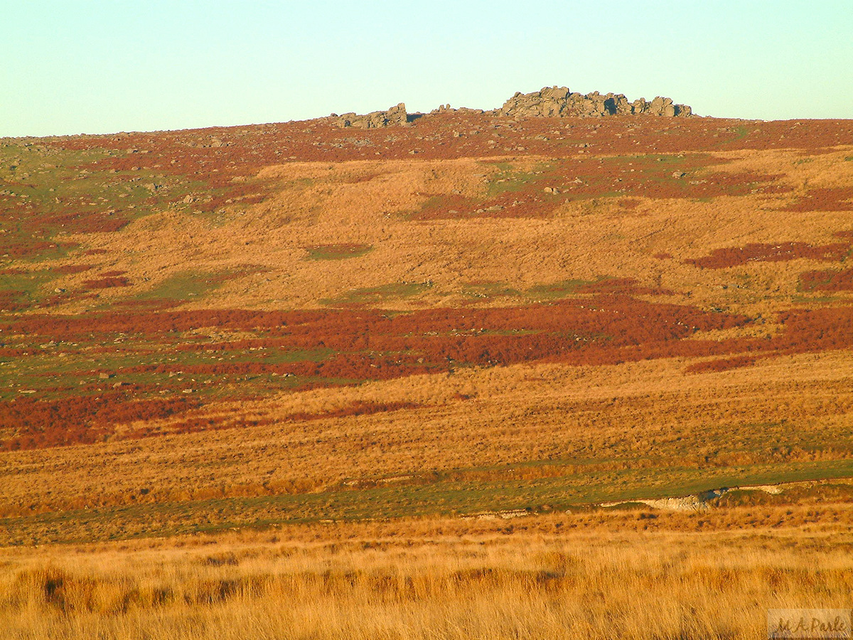 The setting sun gives a red glow to the slopes of Great Trowlesworthy Tor